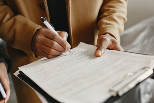 A small business owner signing a document