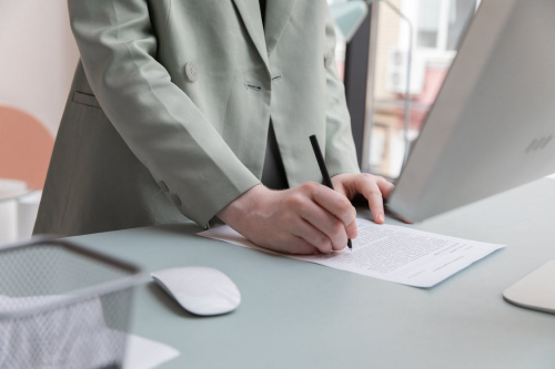 A businessperson signing a document